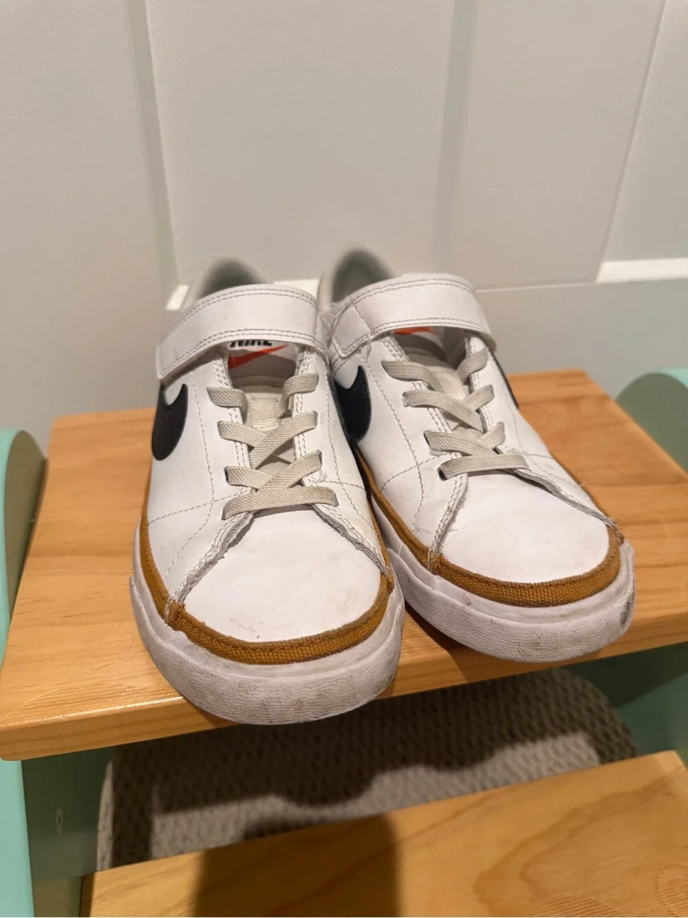 Nike Kids White Sneakers with Black Swoosh and Tan Stripe
